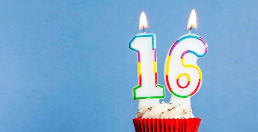 number-16-birthday-candle-cupcake-against-blue-background